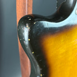 Close-up of a guitar's neck and headstock with a blurred background