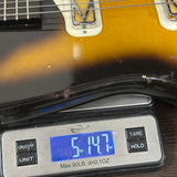 Guitar on a digital scale displaying weight