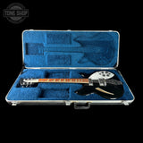 Electric guitar in a blue case with 'Tone Shop' logo in the corner.