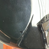 Scratched black surface with a metallic object
