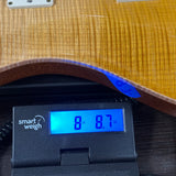 Used PRS TSG Anniversary Wood Library Artist DGT Gold Storm Fade/Braz RW on scale displaying weight.