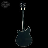 Back view of a black electric guitar on a white background with 'Tone Shop' logo.