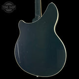 Back view of a blue electric guitar on a black background with 'Tone Shop' logo.