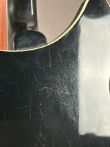 Scratched surface of a guitar with visible wear and tear