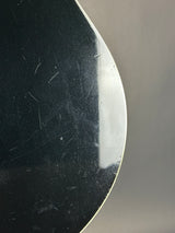 Scratched black surface with a reflective top edge on a gray background