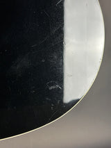 Close-up of a metallic object with a reflective surface on a gray background
