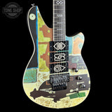 Colorful electric guitar with abstract design on a black background, featuring the Tone Shop logo.