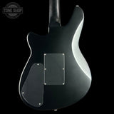 Black electric guitar body with 'Tone Shop' logo in the corner
