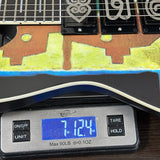 Guitar on a digital scale displaying weight