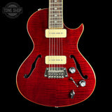 Red electric guitar with a black background