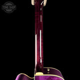 Close-up of a purple guitar with a clear finish on a black background, featuring the Tone Shop logo.