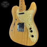 Wooden electric guitar with a visible brand logo on a black background