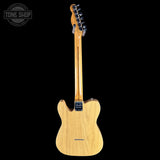 Back view of a Fender electric guitar with 'Tone Shop' logo.