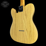 Back view of a Fender electric guitar with a visible brand label on a black background.
