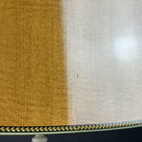 Close-up of a lampshade fabric showing two color options side-by-side: a warm golden-brown textured weave on the left, and a light beige/cream woven texture on the right, finished with a decorative gold and black geometric inlay band at the bottom.