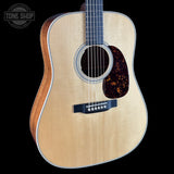 Acoustic guitar with a visible brand logo in the corner