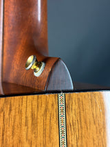 Close-up of a wooden object with a metallic component on a dark background