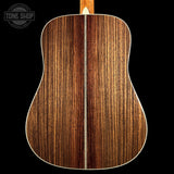 Wooden acoustic guitar back with 'Tone Shop' logo in the corner