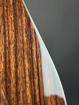 Close-up of a wooden object with a metallic edge on a dark background