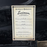 Eastman Certificate of Authenticity for a handcrafted guitar on a dark background