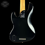 Close-up rear view of a black Fender electric guitar body with a natural wood neck, shown against a black background. A Tone Shop watermark is visible in the upper left corner.