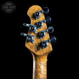 Guitar headstock with tuning pegs on a black background, featuring the Tone Shop logo.