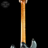 Close-up of a guitar neck with a visible brand logo in the corner.