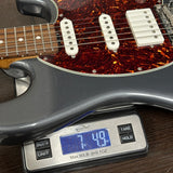 Electric guitar on a digital scale displaying weight