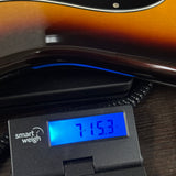 Used 2010 Fender FSR HH Strat Sunburst on scale displaying weight.