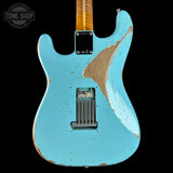 A light blue electric guitar body with a heavily distressed, chipped finish revealing natural wood underneath, shown against a solid black background. A Tone Shop watermark is visible in the top-left corner.