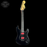 Black electric guitar with red pickups on a black background, featuring 'Tone Shop' logo.