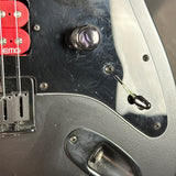 Close-up of a guitar's control panel with visible EMG branding.