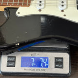 Electric guitar on a digital scale displaying weight