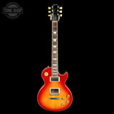 Electric guitar with a sunburst finish on a black background, featuring the Tone Shop logo.