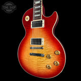 Electric guitar with a sunburst finish on a black background, featuring the Tone Shop logo.