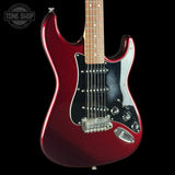 A red glitter electric guitar with a black pickguard and maple neck, shown against a solid black background with a Tone Shop watermark in the top left corner.