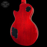 Red electric guitar body on a black background with 'Tone Shop' logo.