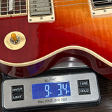 Guitar on a digital scale displaying weight