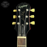 Guitar headstock with 'Epiphone Les Paul' branding on a black background