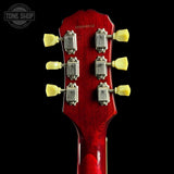 Close-up of a red guitar headstock with tuning pegs on a black background, featuring 'Tone Shop' branding.