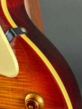 Close-up of a guitar's wood finish and hardware