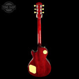 Red electric guitar with a 'Tone Shop' logo in the corner