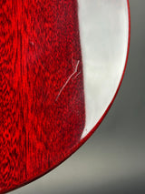 Close-up of a red wooden surface with a white edge