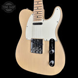 A natural wood electric guitar with a white pickguard, black control plate, and chrome hardware, shown against a solid black background with a Tone Shop watermark in the top left corner.