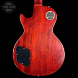 Red electric guitar body with Gibson logo on a black background