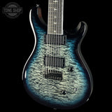 A close-up of an electric guitar body with a blue and black surfin pattern on a black background, featuring a Tone Shop watermark in the top left corner.