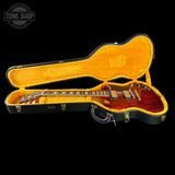 Guitar in an open case with 'Tone Shop' logo in the corner