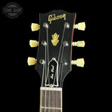 Gibson Les Paul guitar headstock with brand logo on a black background