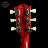 Close-up of a red guitar headstock with tuning pegs on a black background, featuring 'Tone Shop' branding.