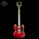 Red electric guitar on a black background with 'Tone Shop' logo.